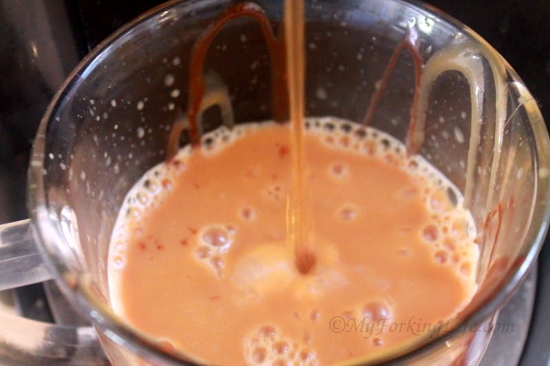 coffee being poured into glass