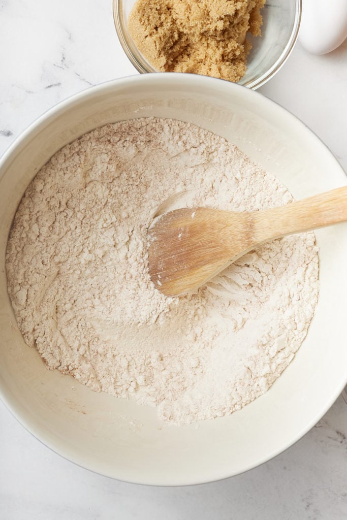 dry spices in a bowl with wooden spoon sticking out