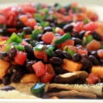 This Sweet Potato and Black Bean Nachos Recipe is the perfect appetizer or dinner for nacho lovers. It can be on your table in less than 30 minutes. #nachos #veganrecipe #vegetarian #meatlessmonday