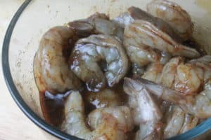 shrimp being marinated in bowl