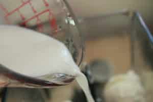 milk being poured into blender