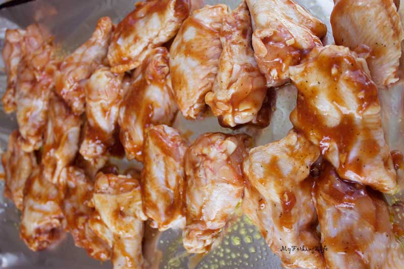 marinated chicken on baking sheet