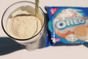 oreo milkshake with straw sticking out and oreos on side