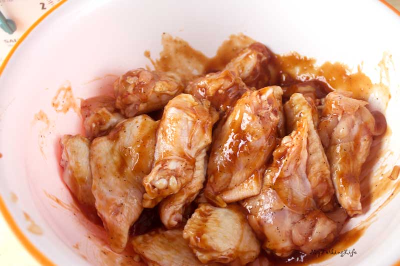 chicken wings covered in sauce in bowl