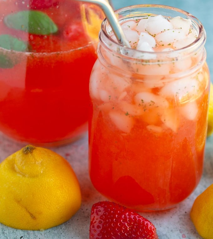 strawberry basil lemonade in glass with stray
