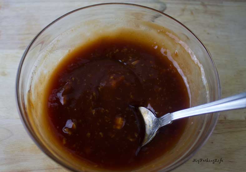 mixed sauce in glass bowl with spoon sticking out