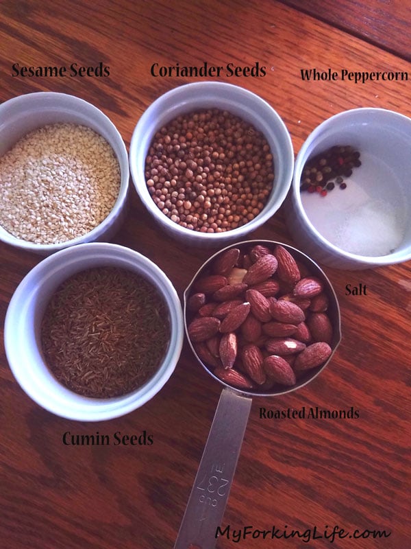 spices and nuts in ramekins on table