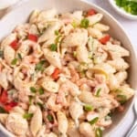 seafood salad in bowl with green onions next to the bowl