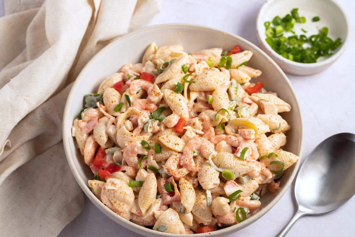 seafood salad in serving bowl with spoon next to bowl