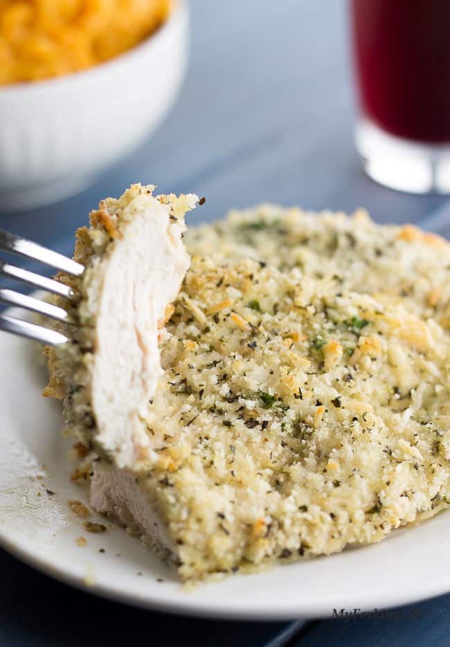 Chicken on white plate cut and piece on fork