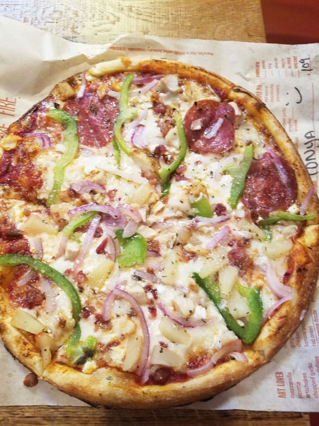 photo of pizza on brown parchment paper