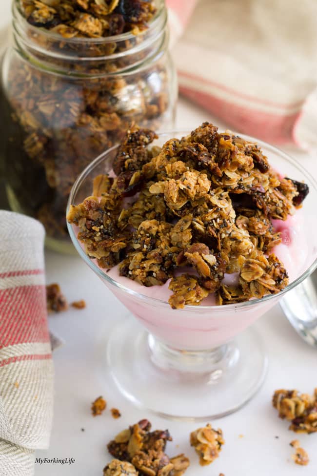 breakfast granola on top of yogurt in glass cup