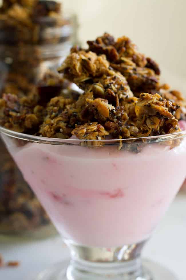 granola in glass bowl over yogurt