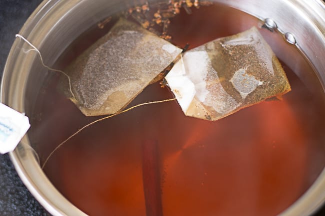 saucepan with tea bags and tea in it