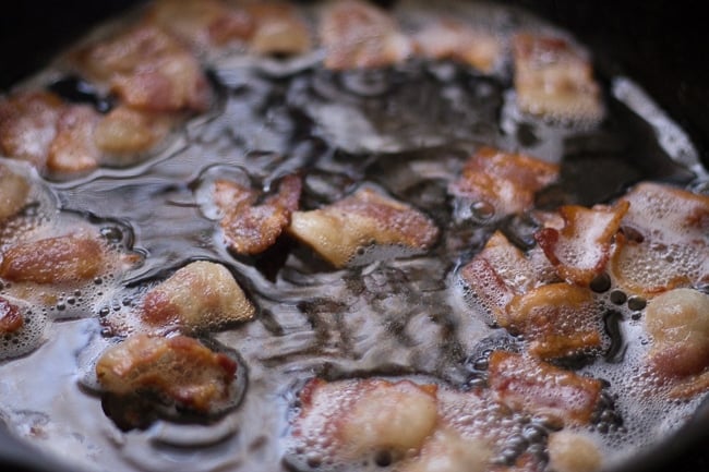 bacon frying in cast iron skillet