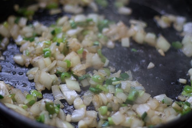 peppers and onions in cast iron skillet