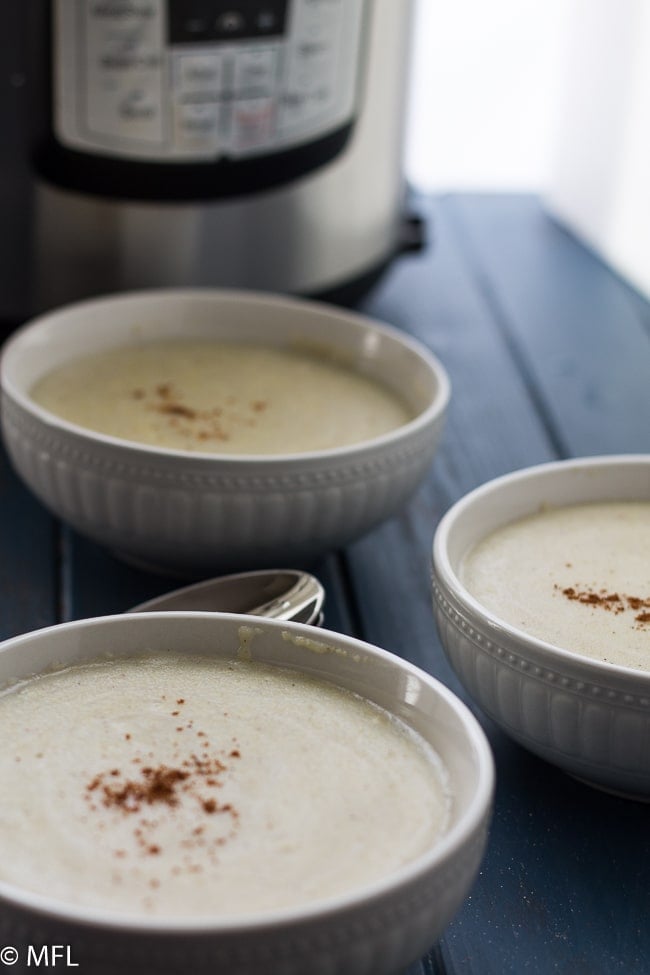 Instapot cornmeal porridge in bowls with instant pot in background