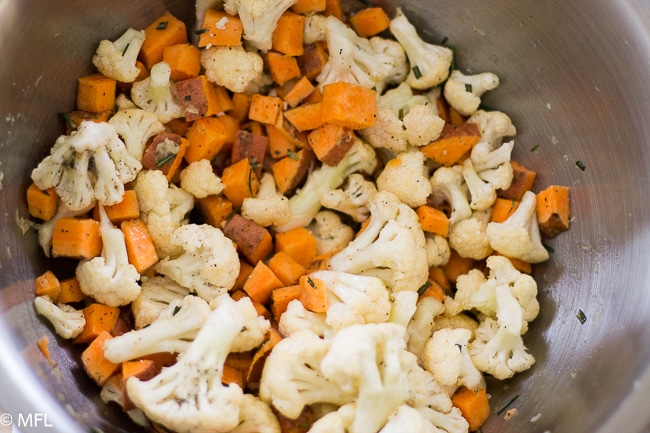 cauliflower, sweet, potato and rosemary mixed in bowl