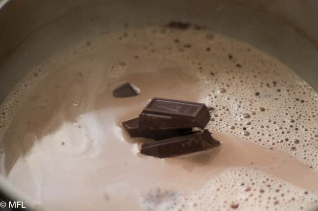 chocolae melting in saucepan in milk and heavy cream