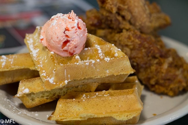 waffles topped with strawberry butter and fried chicken on side