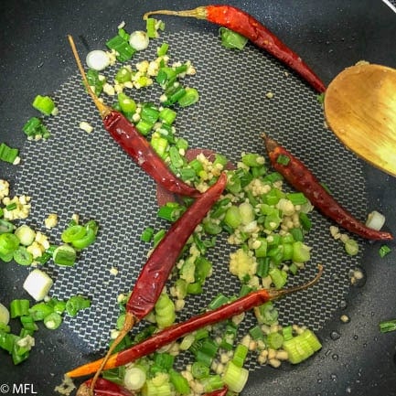 peppers and onions cooking in non stick skillet