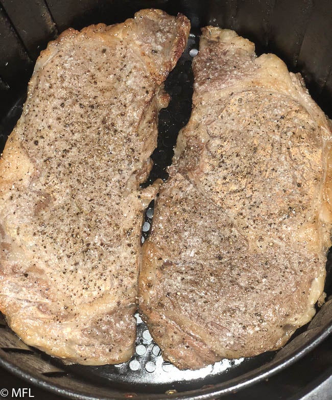 cooked steak in air fryer basket