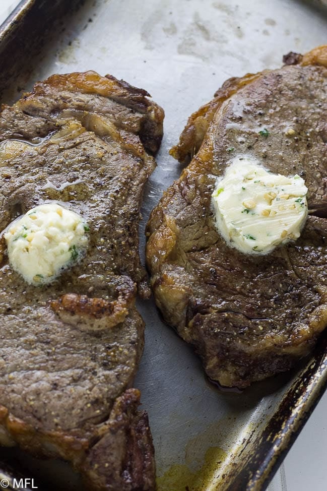 air fried steak on metal pan with butter on top