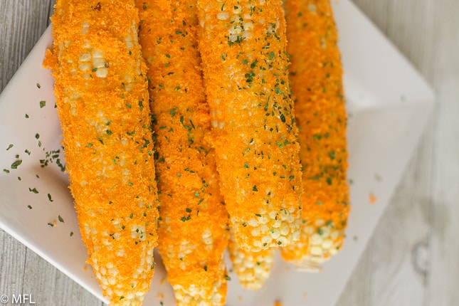 corn on the cob on white plate