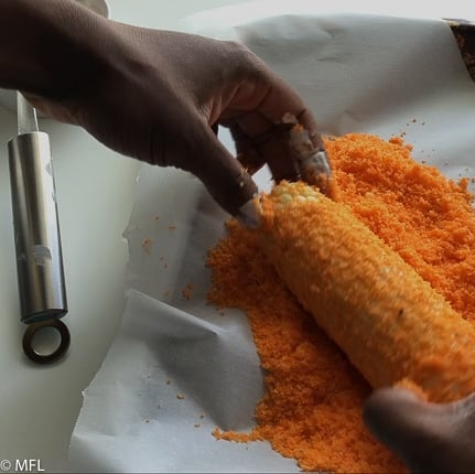 corn being rolled in crushed chips