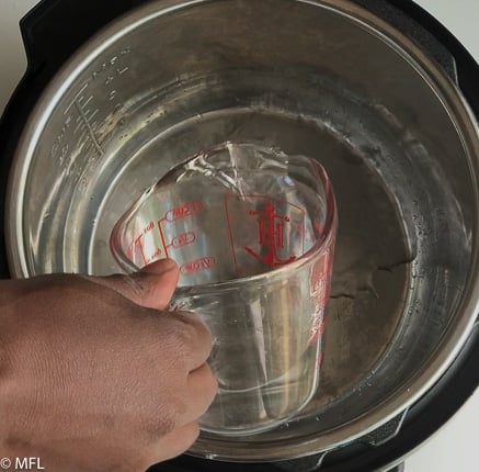 water being poured into instant pot insert