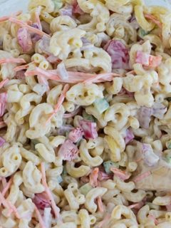 This Hawaiian Macaroni Salad is a sweet and tangy macaroni salad that is a twist on traditional macaroni salad. Covered in a delicious creamy sauce with bright vegetables, it's perfect for summer. #easy #hawaiian #sidedish #cookoutsides #mealprep #pastasalad #picnicsalad #summersalad #hawaiianmacaronisalad #myforkinglife