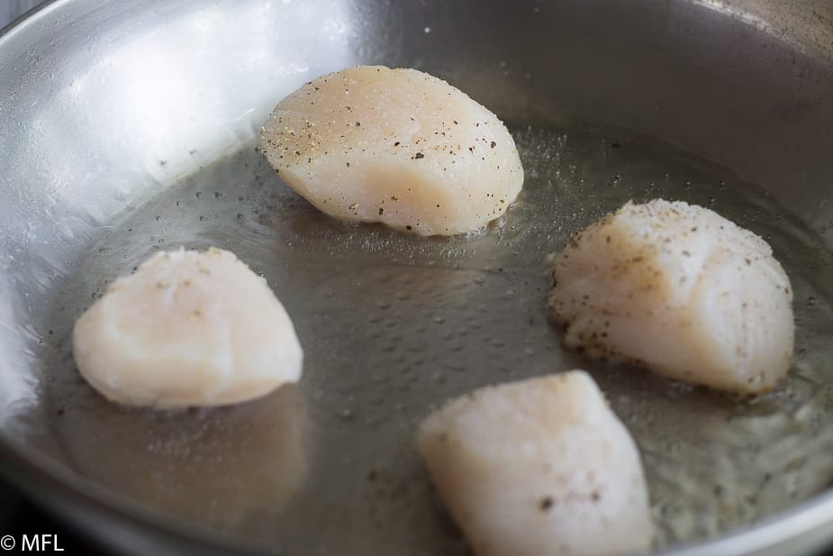scallop cooking in skillet