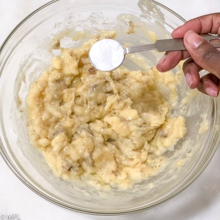 baking soda in teaspoon over bowl