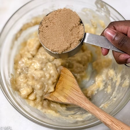 brown sugar in cup over bowl