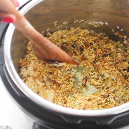 rice and wodden spoon in instant pot