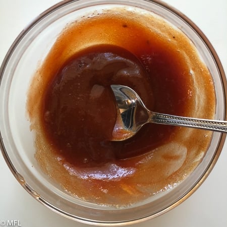 sauce in glass bowl with spoon