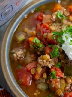 final photo shot of pressure cooker lentil soup with sour cream on top