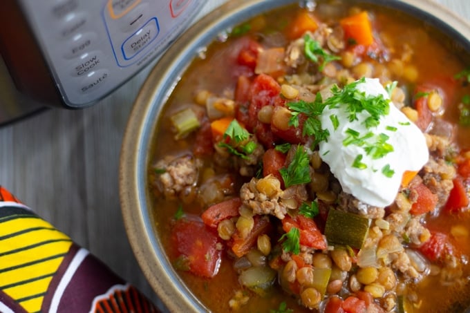 final photo shot of pressure cooker lentil soup with sour cream on top