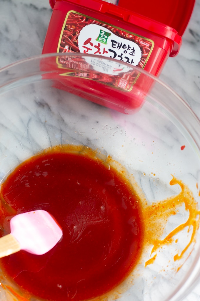 sauce for brussels sprouts in bowl with gochujang container to side