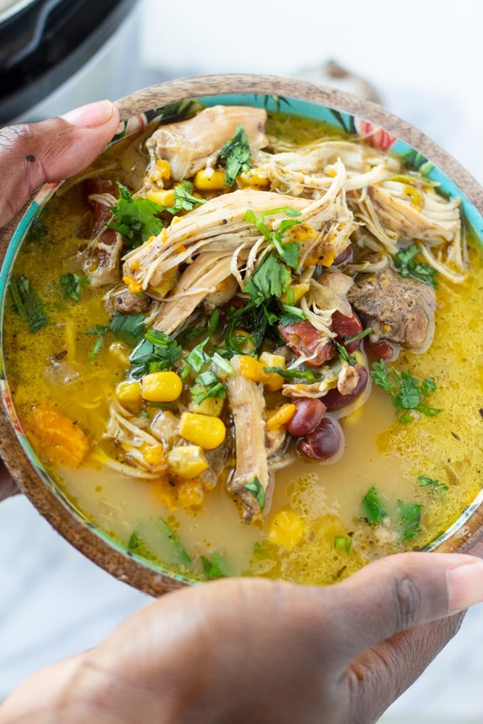 "This Jamaican Jerk Chicken Soup made in your Instant Pot is a delicious spin on traditional chicken soup. Made with authentic jerk seasonings. #instantpot #soup #caribbeanrecipe #jerkchicken #pressurecookerrecipes" finished jer chicken soup in a bowl