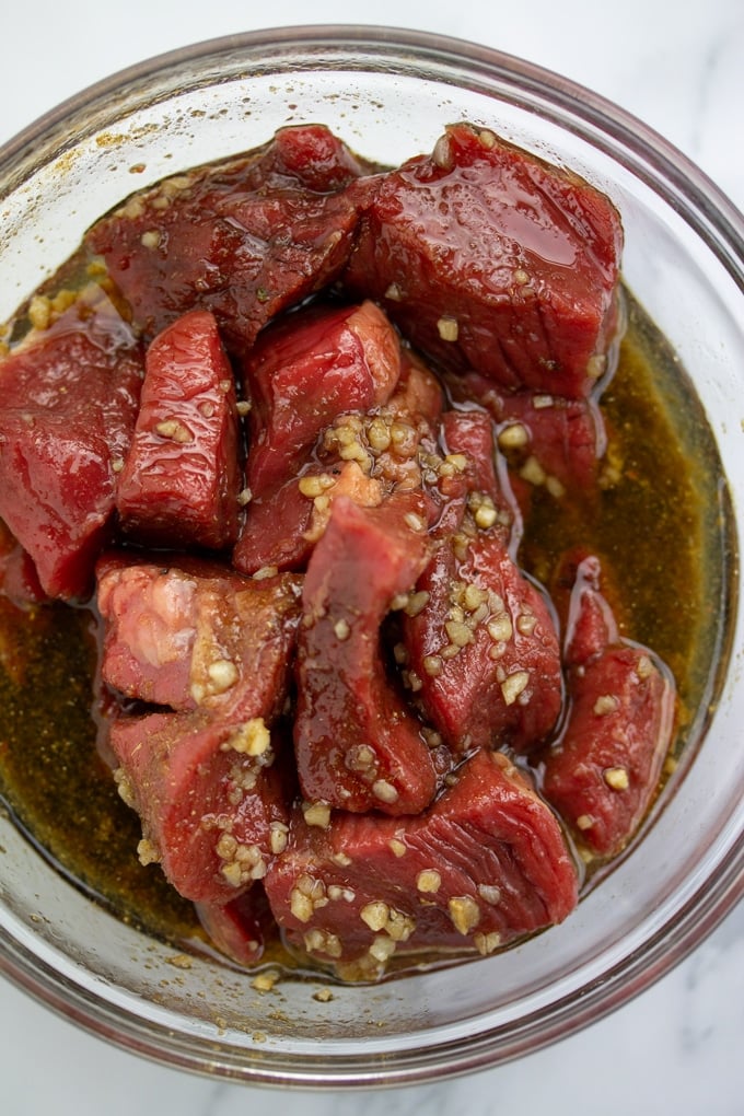 steak for kebabs in marinade in bowl