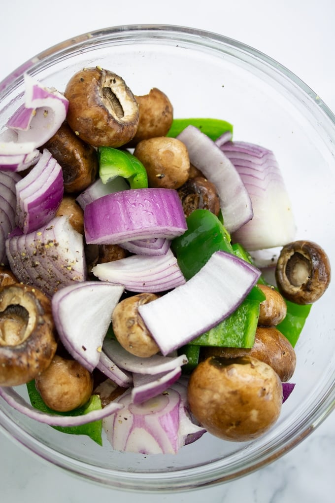 onions, peppers, and mushrooms chopped and mixed in bowl