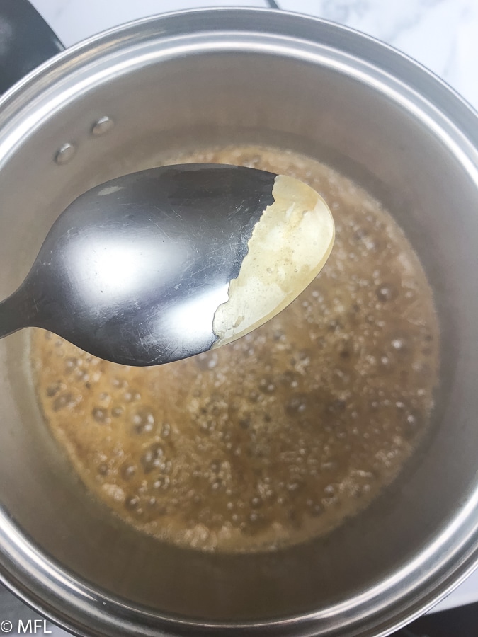 back of spoon after dipping in caramel glaze