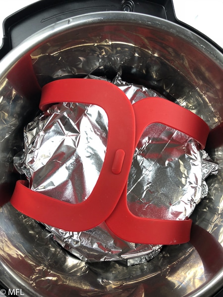 instant pot carrot cheesecake covered by foil inside of Instant pot 