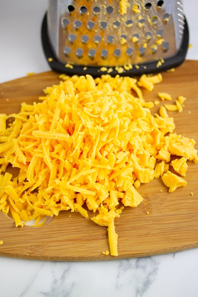 shredded cheese for the instant pot grits recipe laid out in front of a grater