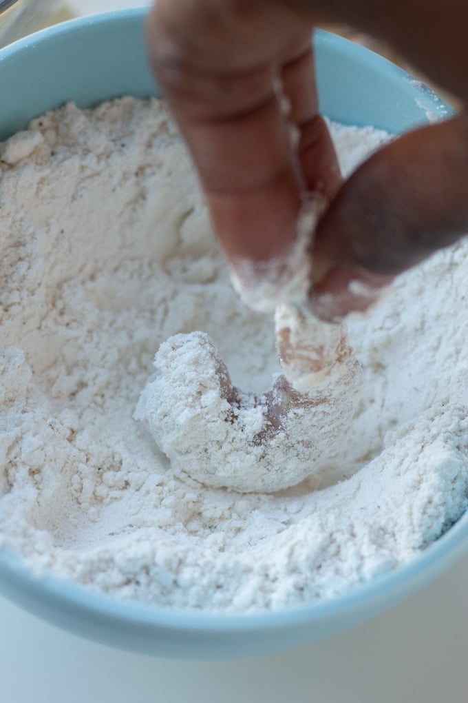 shrimp being dipped in flour