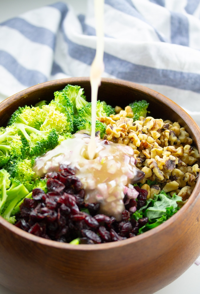 salad dressing being poured into salad bowl