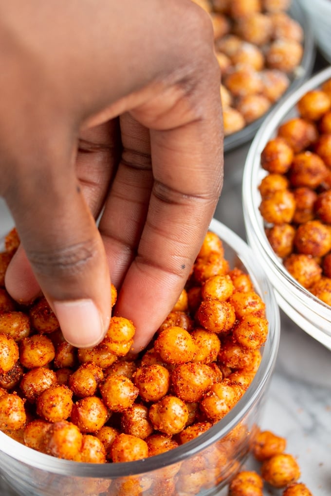 Hand picking up air fryer chickpeas