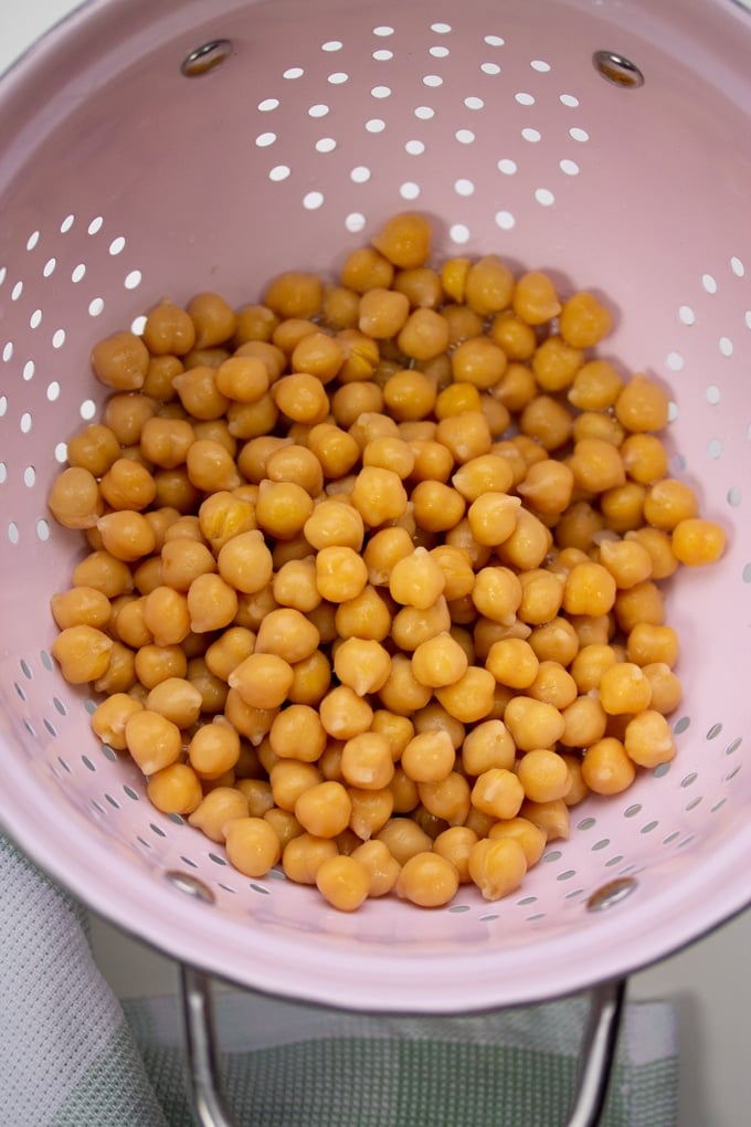 chickpeas drained in a pink colander