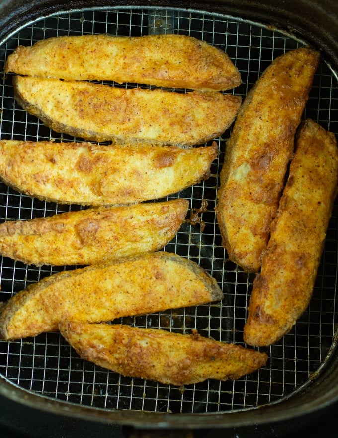 finished air fryer potato wedges in air fryer basket